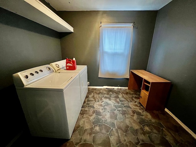 clothes washing area with washing machine and dryer