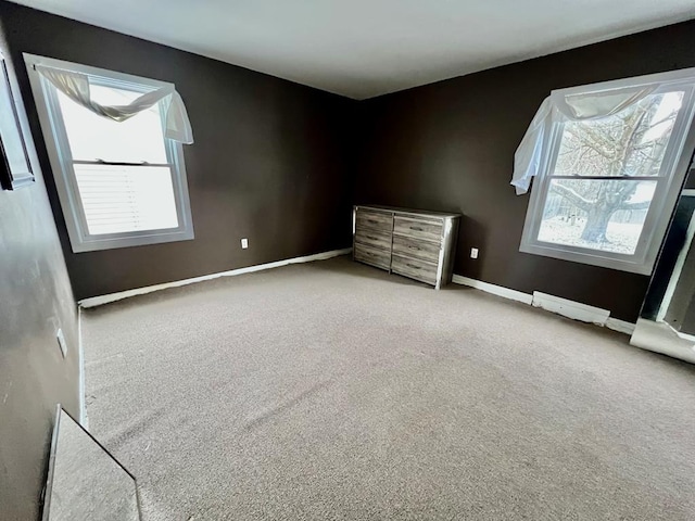 unfurnished bedroom featuring light carpet