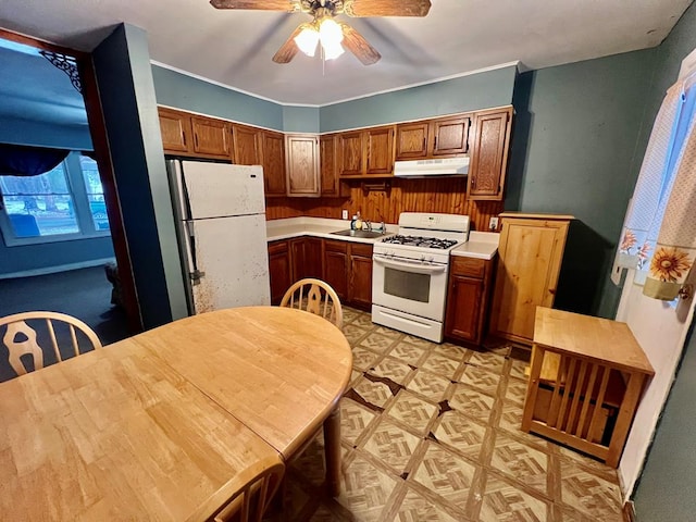 kitchen with ceiling fan, sink, and white appliances