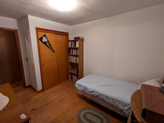 bedroom featuring hardwood / wood-style floors and a closet