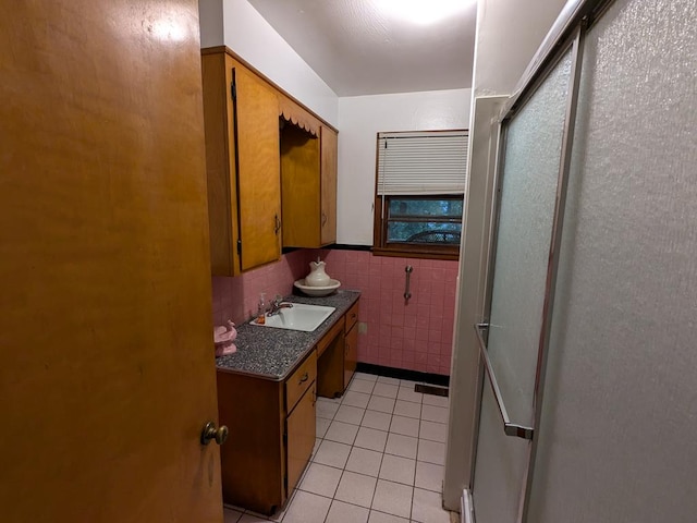 bathroom featuring tile patterned floors, vanity, and tile walls