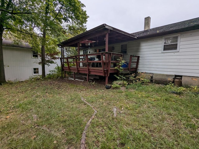 back of house with a yard and a deck