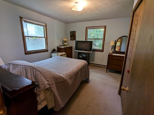 bedroom with a textured ceiling, light carpet, and a baseboard radiator