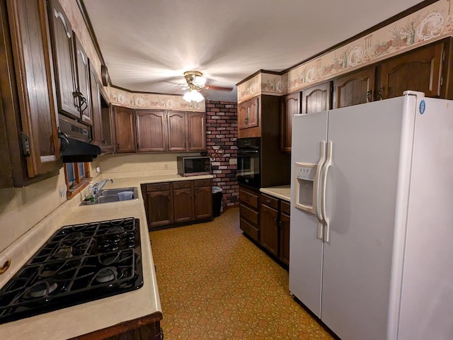 kitchen featuring dark brown cabinetry, sink, and black appliances