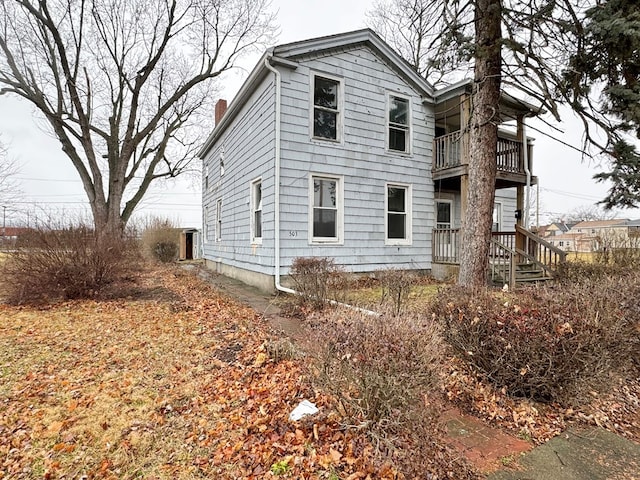 view of home's exterior with a balcony