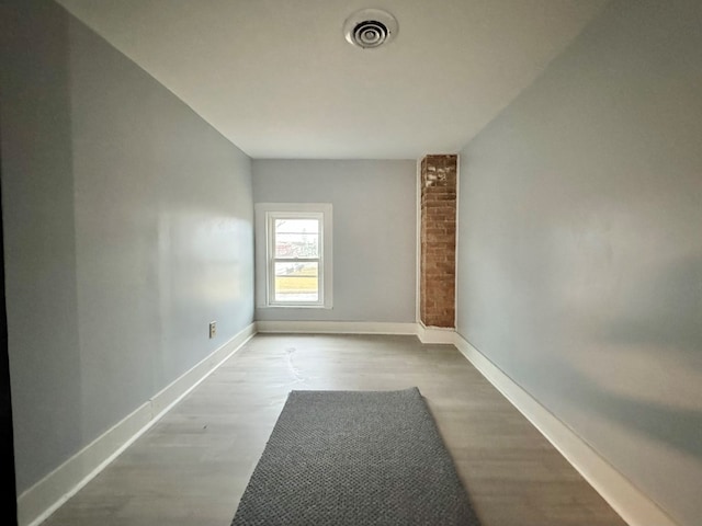 empty room with light hardwood / wood-style flooring