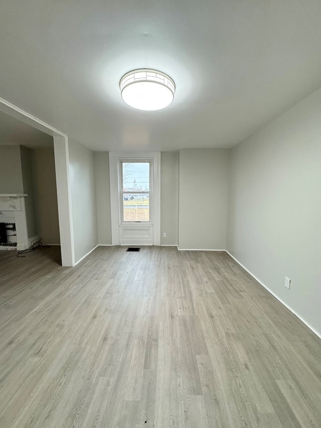 empty room with light hardwood / wood-style flooring