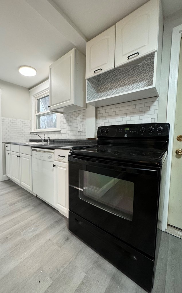 kitchen featuring dishwasher, light hardwood / wood-style floors, white cabinetry, and black range with electric cooktop