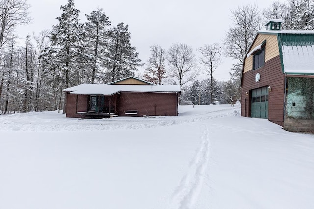 yard covered in snow with a garage