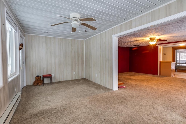 carpeted empty room with ceiling fan and a baseboard radiator