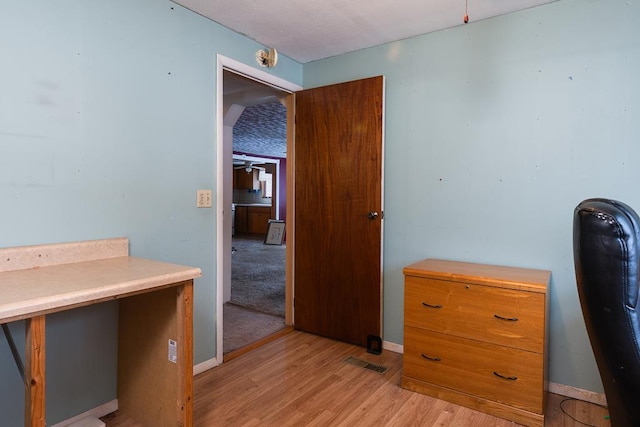 unfurnished office featuring light hardwood / wood-style flooring