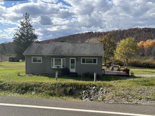 single story home with a wooden deck