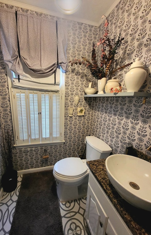 bathroom with vanity, ornamental molding, and toilet