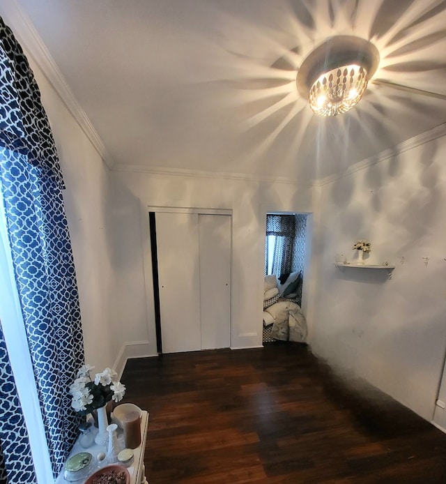 corridor with dark wood-type flooring and ornamental molding