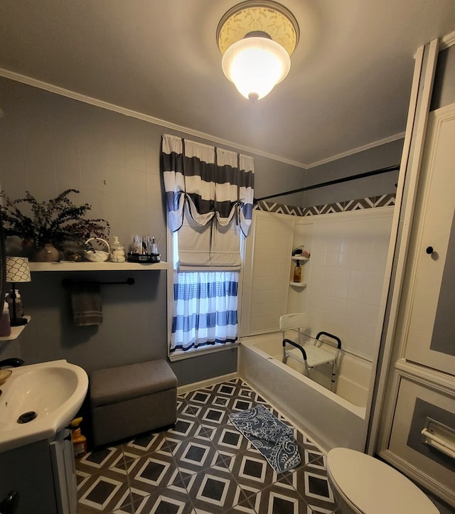 full bathroom featuring vanity, ornamental molding, toilet, and tiled shower / bath