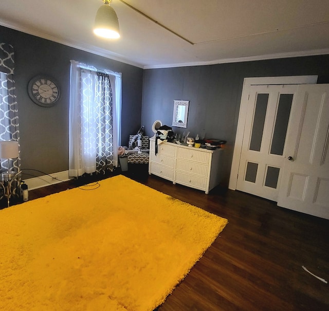 unfurnished bedroom featuring crown molding and dark hardwood / wood-style floors