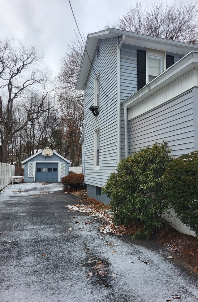 view of side of home with a garage and an outdoor structure