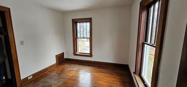 unfurnished room with dark hardwood / wood-style flooring