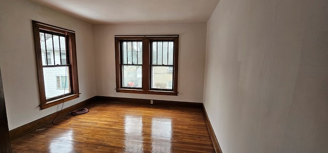 unfurnished room with wood-type flooring