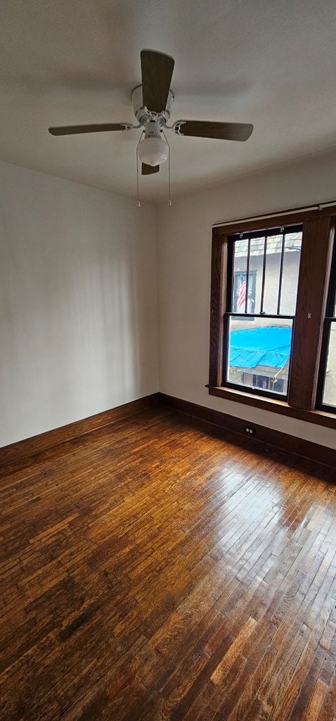 spare room featuring hardwood / wood-style floors and ceiling fan