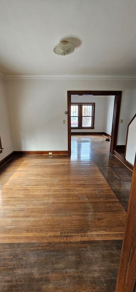 spare room with ornamental molding and hardwood / wood-style floors