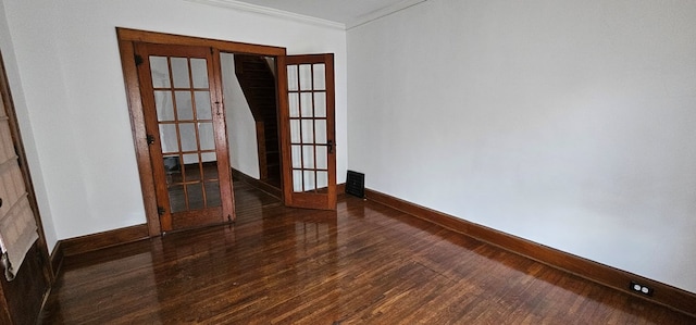 spare room with french doors, dark hardwood / wood-style floors, and crown molding