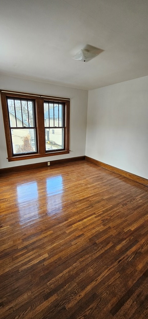 unfurnished room featuring dark hardwood / wood-style flooring