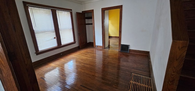 unfurnished room featuring ornamental molding, hardwood / wood-style floors, and a wealth of natural light