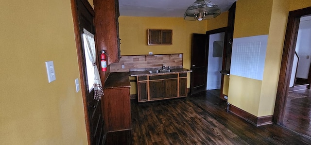 kitchen featuring sink, dark wood-type flooring, and decorative backsplash