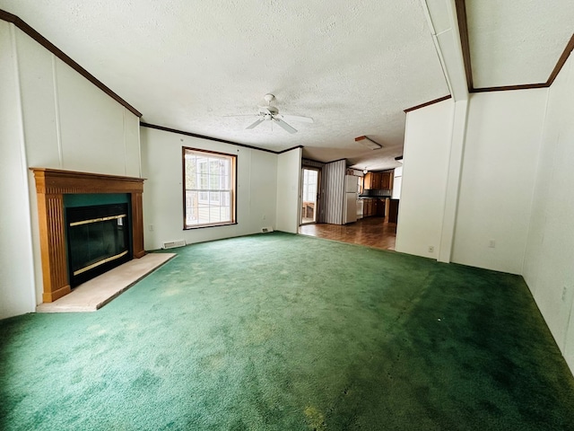 unfurnished living room with ceiling fan, crown molding, carpet floors, and a textured ceiling