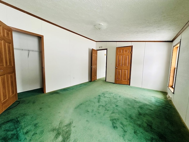 unfurnished bedroom featuring carpet floors, a textured ceiling, and ornamental molding