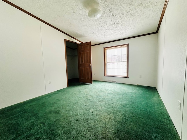 unfurnished bedroom with a textured ceiling, carpet floors, and lofted ceiling