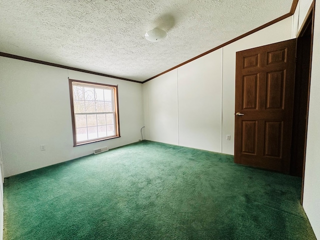 carpeted spare room with a textured ceiling