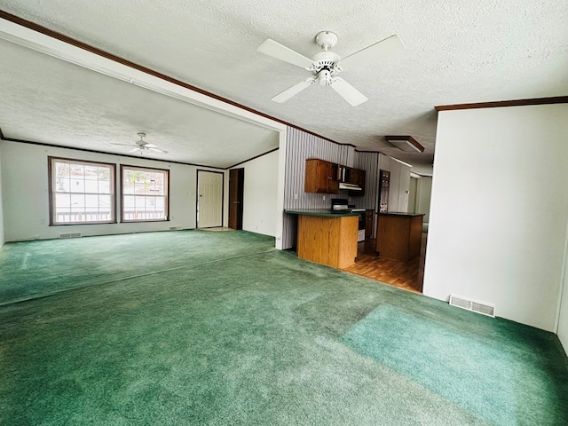 unfurnished living room with dark colored carpet, a textured ceiling, and lofted ceiling