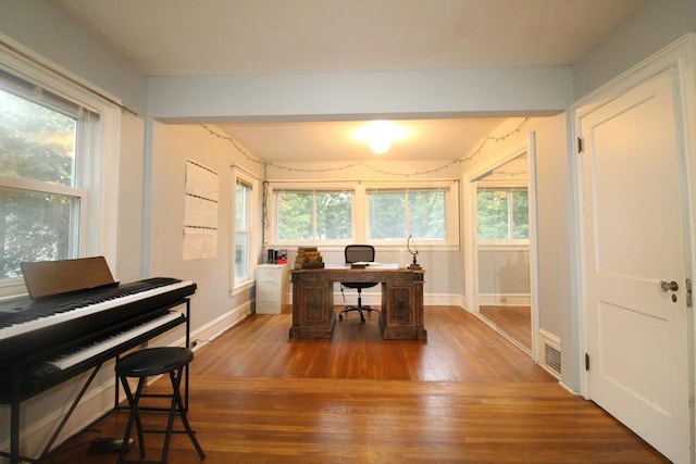 office space with dark wood-type flooring