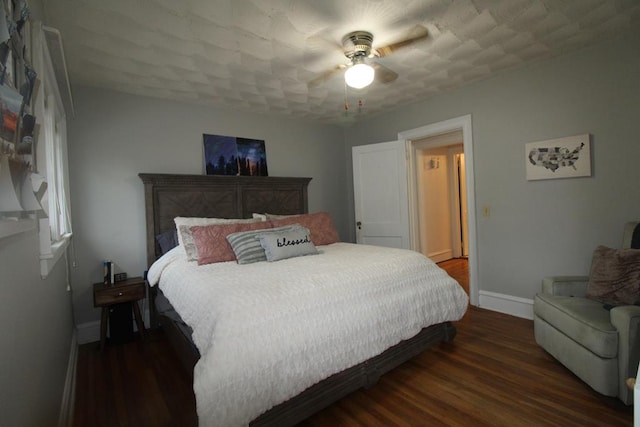 bedroom featuring ceiling fan and dark wood-type flooring