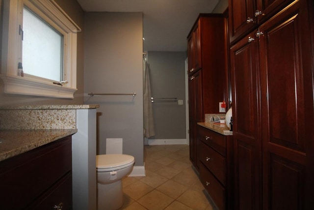 bathroom featuring tile patterned floors, vanity, and toilet