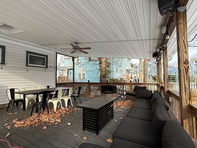 wooden terrace with ceiling fan and an outdoor living space