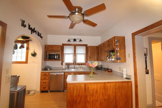 kitchen featuring tasteful backsplash, a wealth of natural light, dishwasher, and sink