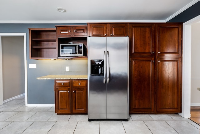 kitchen featuring light tile patterned floors, crown molding, and appliances with stainless steel finishes