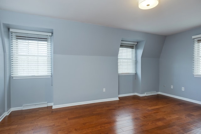 unfurnished room with dark hardwood / wood-style flooring and lofted ceiling