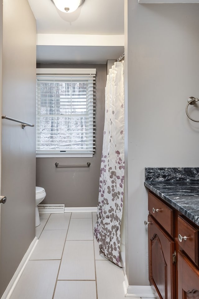 bathroom with tile patterned floors, toilet, and vanity