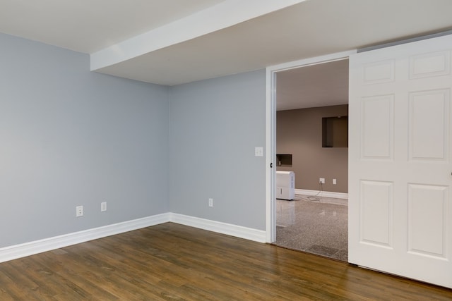 empty room featuring dark wood-type flooring