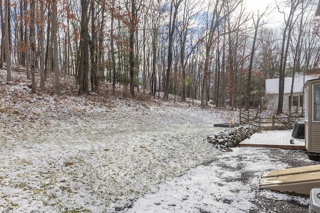 snowy yard featuring a deck