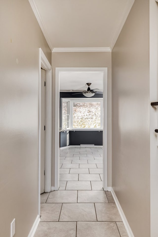 corridor with light tile patterned floors and ornamental molding