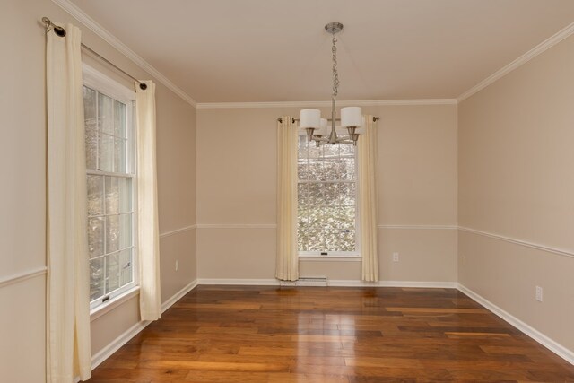 unfurnished dining area with a notable chandelier, crown molding, and dark wood-type flooring