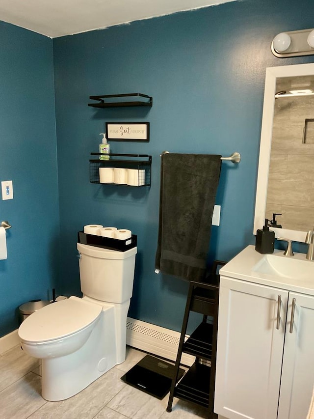 bathroom with baseboard heating, vanity, and toilet