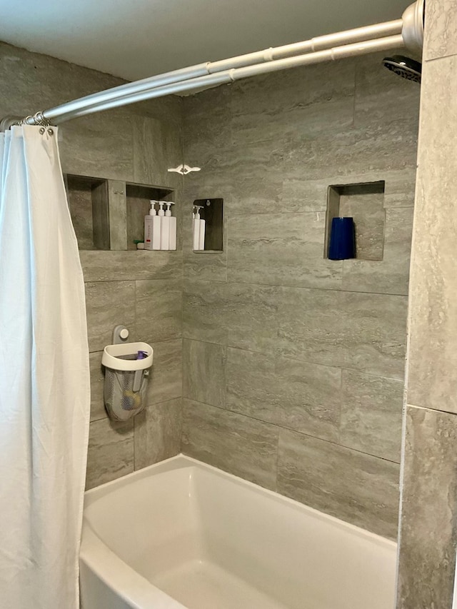 bathroom with shower / bath combination with curtain