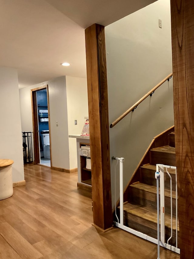 stairway with hardwood / wood-style floors