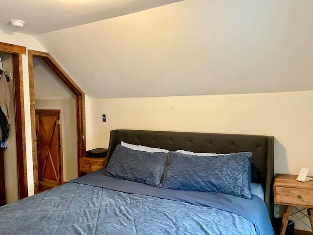 bedroom with lofted ceiling